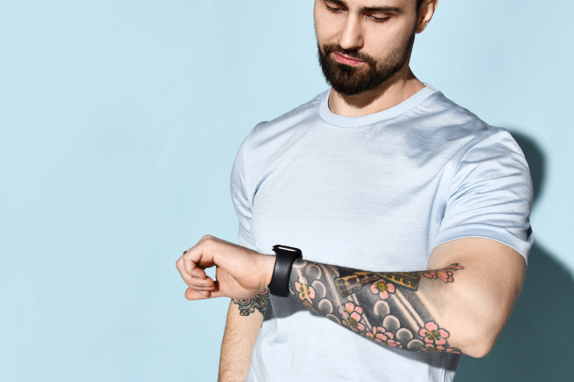background containing tattooed smartwatch user